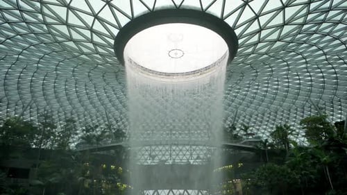 Magnificent vortex with waterfall inside architecture at Singapore airport.