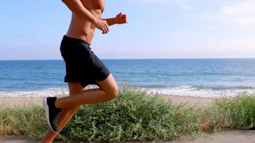 Athletic Man Exercising At The Beach