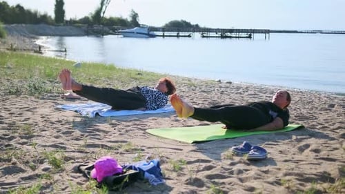 Women Practice Pilates on Lakeside Beach Activating Deep Muscles