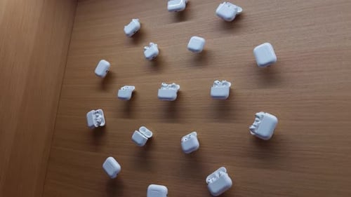 Wireless Earbud Cases Arranged on a Wooden Background