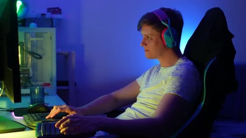 Young Man Playing Video Games and Celebrating Victory