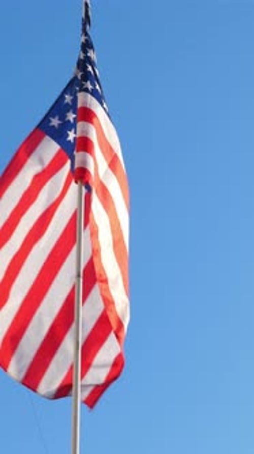 American Flag Waving Against a Clear Blue Sky