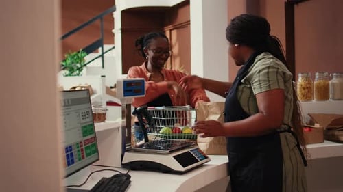 Woman Buying Vegetables at Store Counter