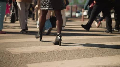 People Cross Street at Zebra Crossing in City
