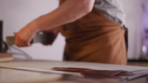Craftsman Puts Stand for Leather Processing on Table