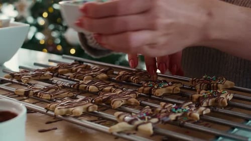 Woman Decorates Festive Christmas Star Cookies