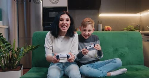 Excited Woman and Child Playing Video Games at Home