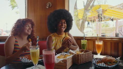 Multi-ethnic friends eating and having fun in a restaurant