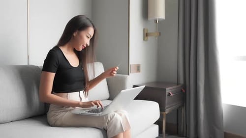 Busy asian corporate woman ordering online at home