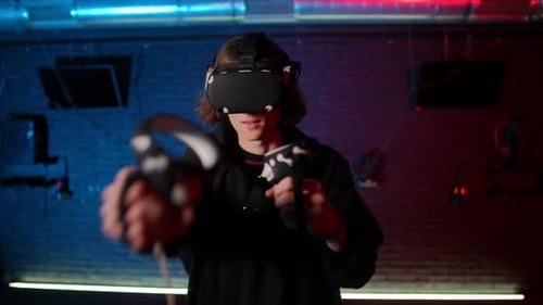 Man Using Virtual Reality Headset and Controllers