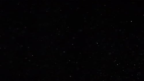 Abstract Swirling Dust Particles on Dark Background