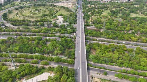 Aerial drone shot highlighting the structured and spacious road network in Noida city.