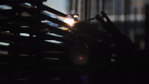 Welder Attaches Metal Rods with Welding Tool