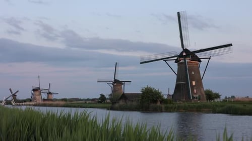 Beautiful wooden windmills at sunset in the Dutch village of Kinderdijk. Windmills run on the wind.