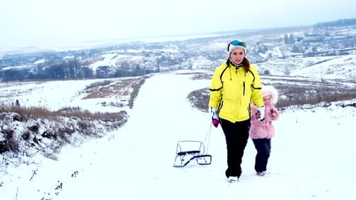 Mother and Child Walking in Snowy Winter Landscape