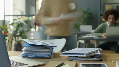Timelapse of Office Workers Stacking Papers on Desk