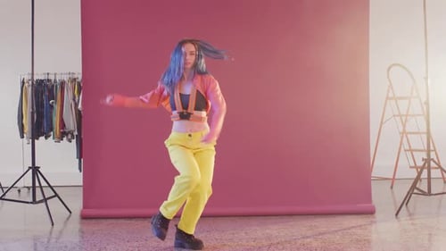 Portrait of happy caucasian female dancer dancing in dance studio, slow motion