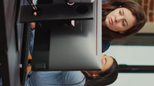 Vertical Video Diverse Team of Employees Analyzing Project Component on Multi Screens