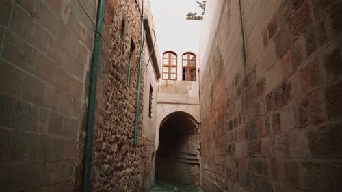 A Tunnel Passing Through Narrow Streets with Stone Houses