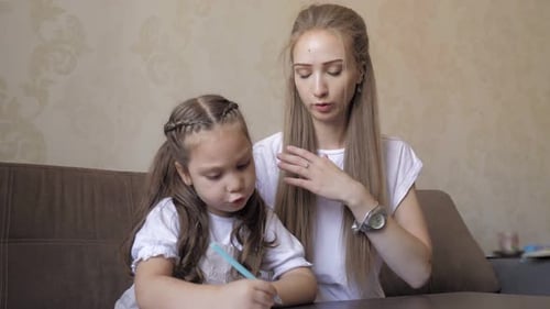 Loving Mother Helps Young Daughter Draw