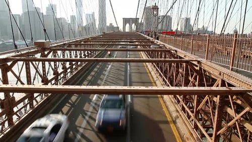 Golden hour traffic flows on the iconic brooklyn bridge in New York City