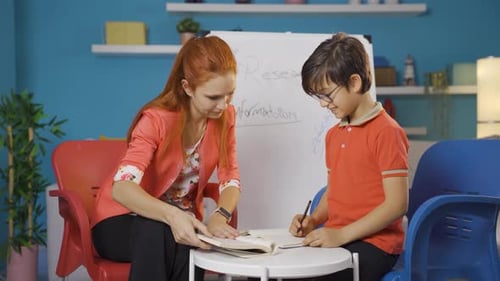 Tutor Helping Child with Schoolwork at Home