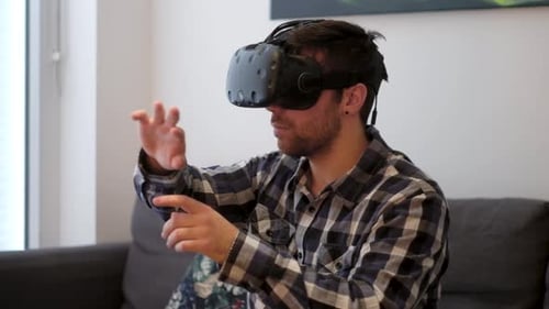 Young Man Using Virtual Reality Headset Indoors