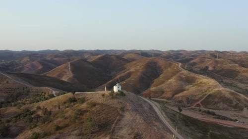 video of hills and wind resources as energy. broken windmill. aerial footage of a windmill on a hill