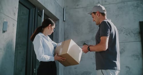 Postman Coming to Modern Office Building Delivering Parcel Box for Recipient