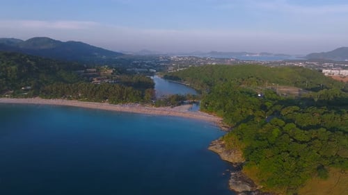 Aerial View of Phuket Island Showing a Serene Beach Lush Green Hills a Calm Blue Sea