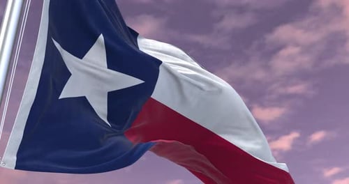 Realistic Texas Flag Waving Against Cloudy Sunset Sky