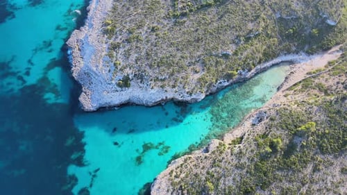 Aerial View of Turquoise Coastline and Rocky Cliffs