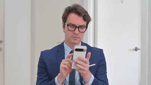 Adult Man Uses Smartphone, Close Up Indoors