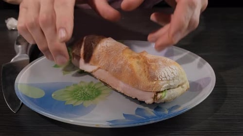Hands Unwrapping Delicious Sandwich on Plate