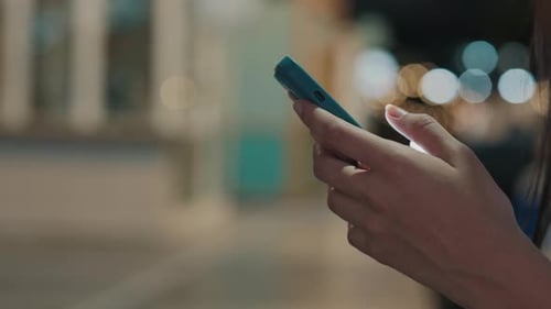 Close View Woman Hands Holding the Green Smartphone and Texting in Internet Standing Outside at