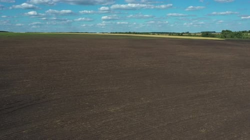 Aerial view of a plowed field ready for sowing as background. Shot from drone.