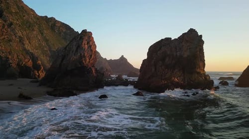 Breathtaking Coastal Rock Formation Captivatingly Lit By the Warm Glow of the Sunset