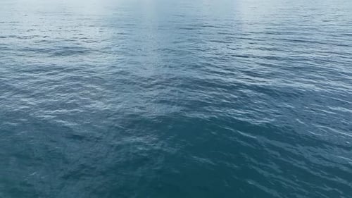 Luftvideo Wunderschöne Ozeantextur mit subtilen Wellen und Reflexionen unter klarem Himmel