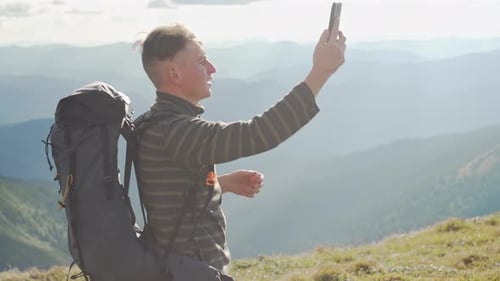 A Man Looking for a Telephone Connection in the Mountains There is No Network