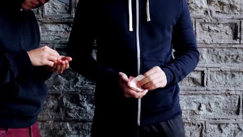 Men Exchange Small White Package in Alleyway