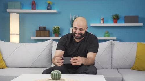 Frustrated Man Installs SIM Card Into Phone