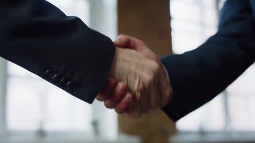 Closeup Men Shaking Hands at Office Meeting