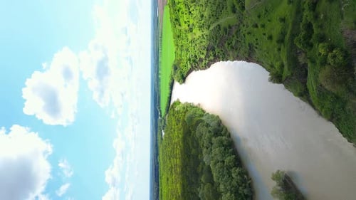 Vertical Video Landscape of Nature Concept Aerial View of the River Quadcopter Flying Over a Green