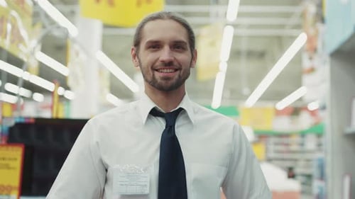Attractive Man the Seller Work Look at Camera in Tech Department in Supermarket Feel Happy Business