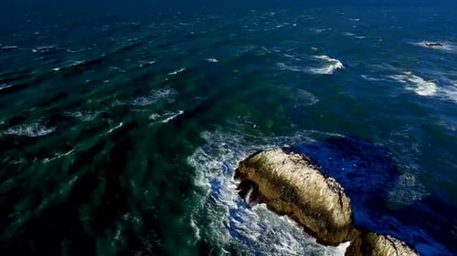 Drone View Of Choppy Ocean And Rocks By San Francisco Beachside 4