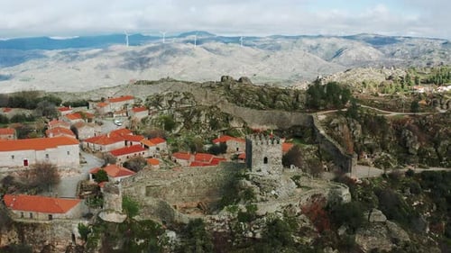 historical Iberian walled town and castle remnants on rugged hilltop, Sortelha, Portugal, dolly in a