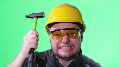 Construction Worker Strikes with a Hammer Using a Handheld Metal Tool Crazy Construction Worker