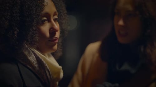 Two Women Conversing Outdoors at Night