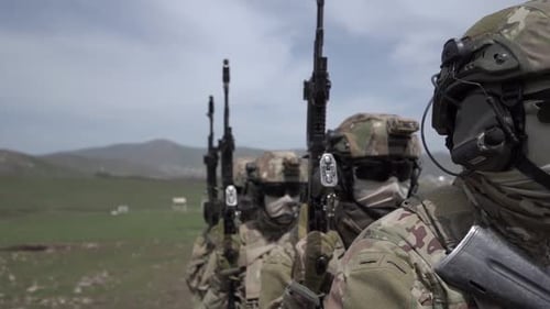 Solemn Soldiers Standing in Formation with Weapons