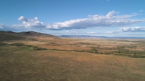 Aerial Panoramic View of a Steppe Hills Against Blue Sky Majestic Nature